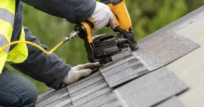 Roof repair work on asphalt shingles